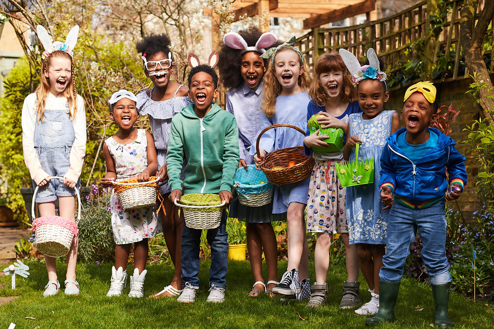 young children laughing and holding baskets and dressed for easter