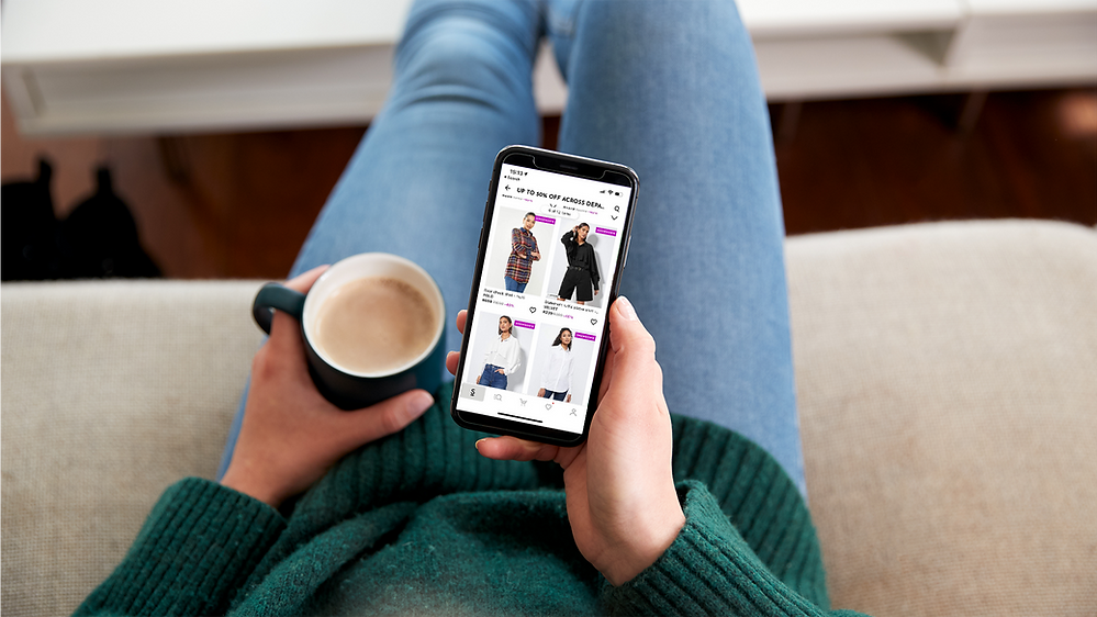 woman on phone holding mobile phone with superbalist on screen