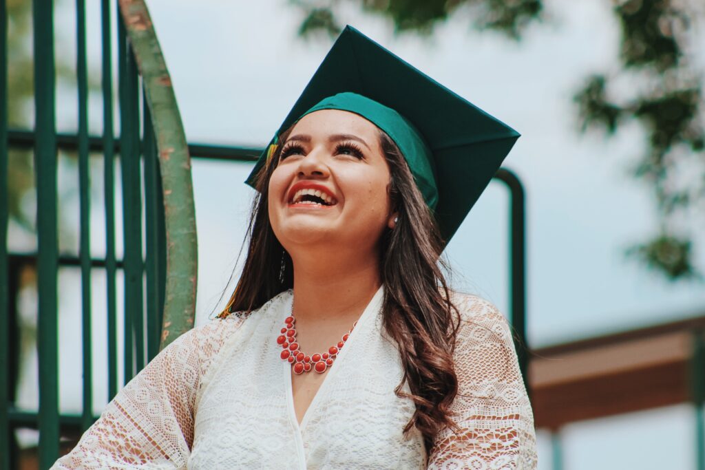 woman looking up with graduation hat on
