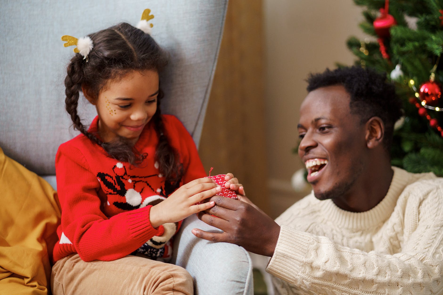 dad giving a christmas present to his daughter