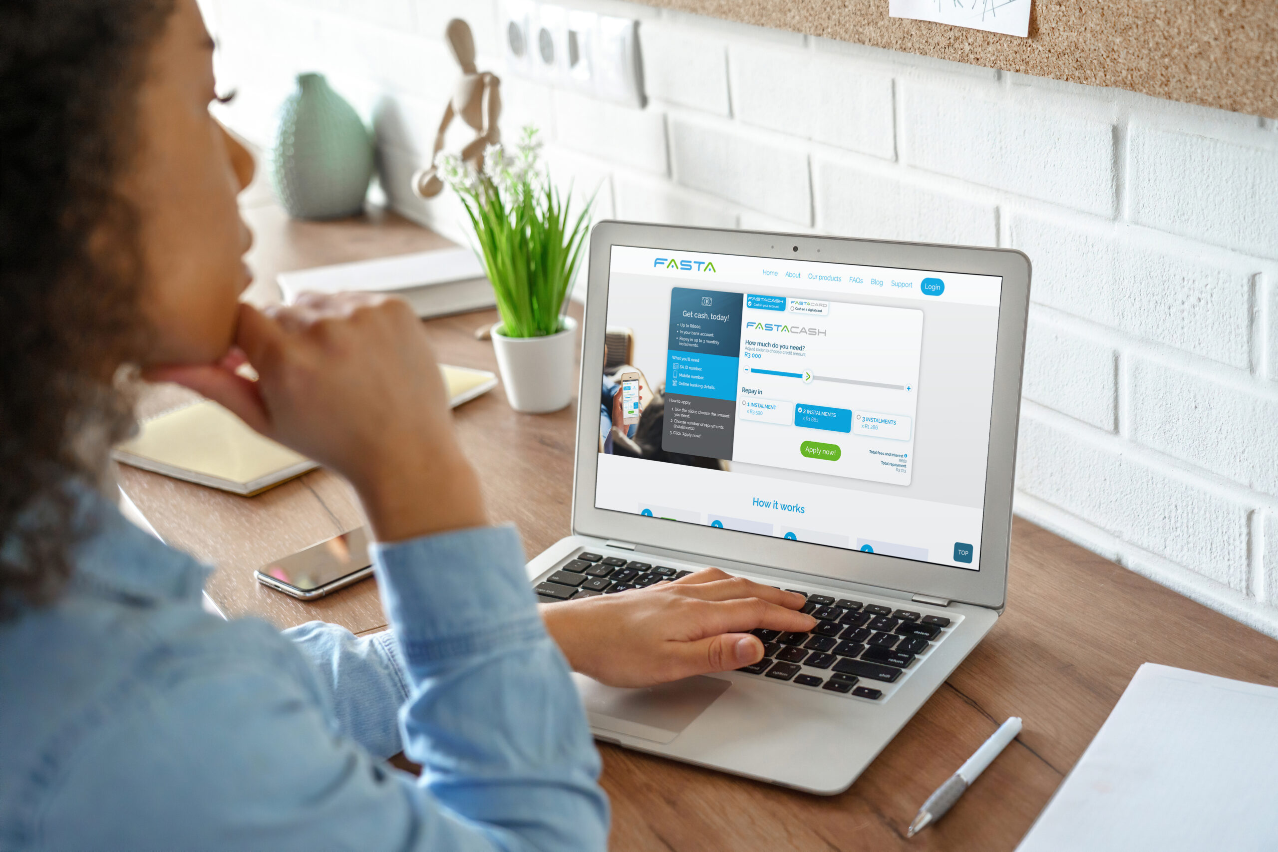 woman looking at laptop with fasta loan website on screen