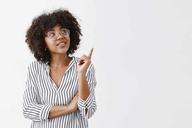 young woman wearing glasses and looking up in thought