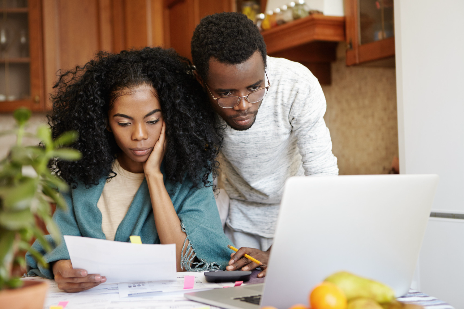 young couple looking at papers to apply for a quick loan