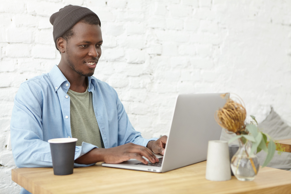 man on laptop with coffee